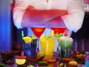 Drink recipes in front of a bartender