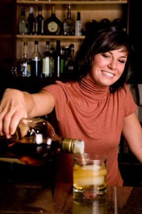A good bartender pouring a drink